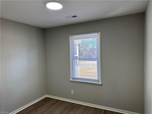 spare room featuring dark hardwood / wood-style flooring