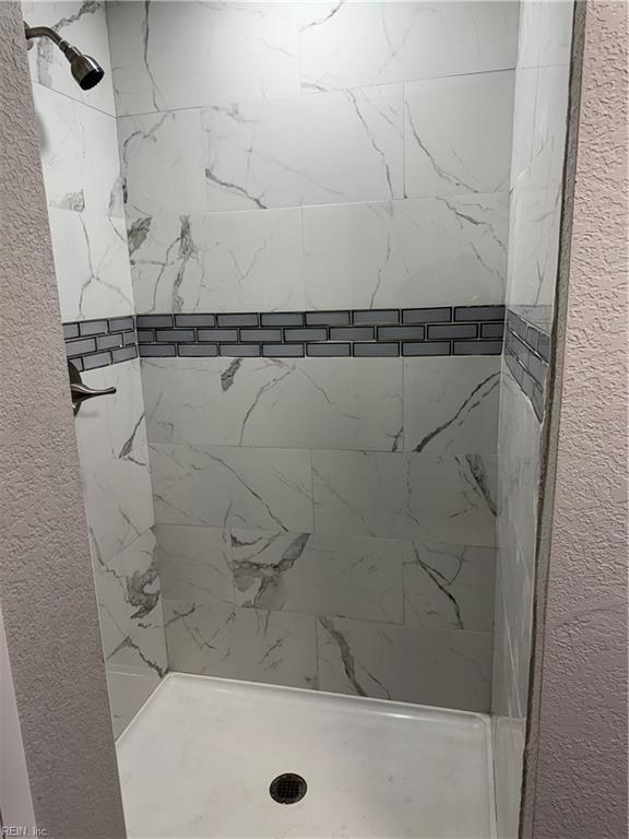 bathroom with a tile shower