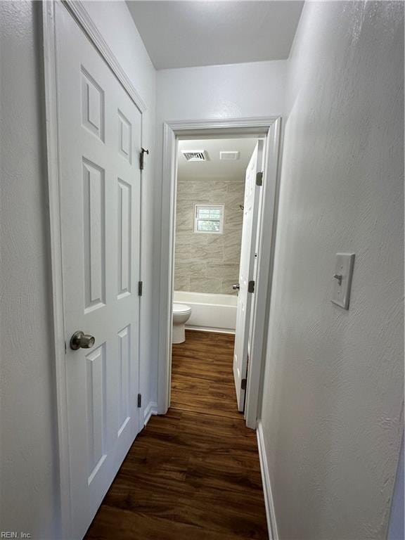 corridor with dark wood-type flooring