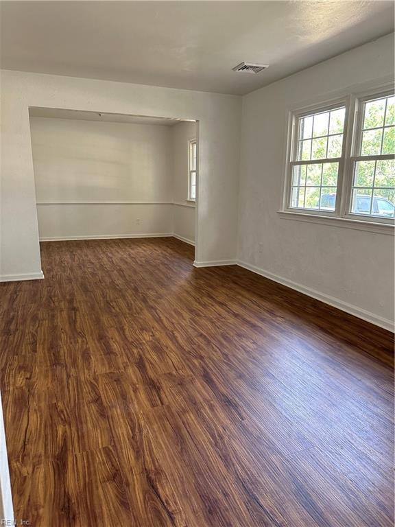 unfurnished room featuring dark hardwood / wood-style floors