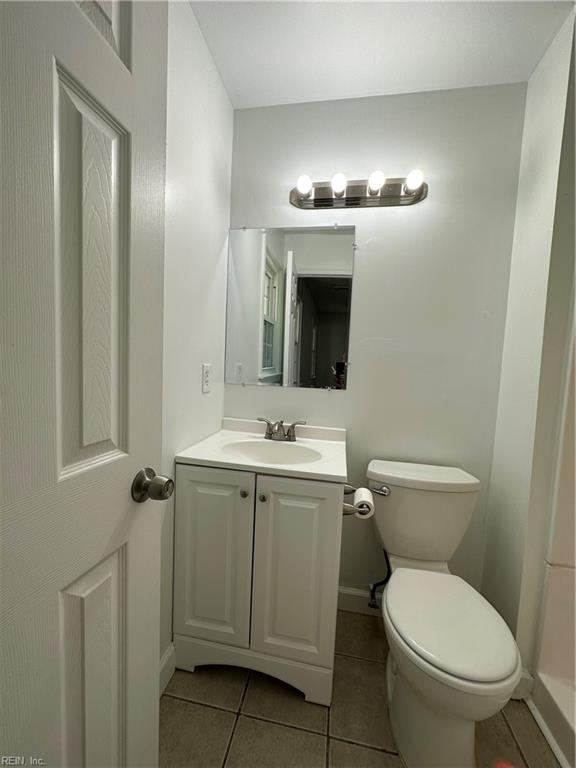 bathroom featuring toilet, vanity, and tile patterned floors