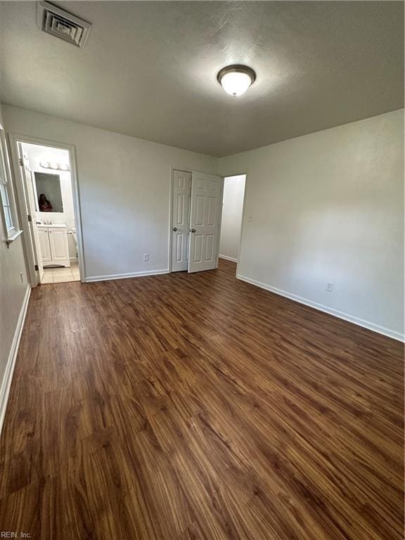 spare room with dark hardwood / wood-style flooring