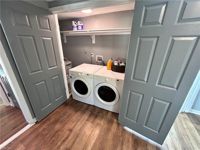 clothes washing area featuring dark hardwood / wood-style flooring and separate washer and dryer