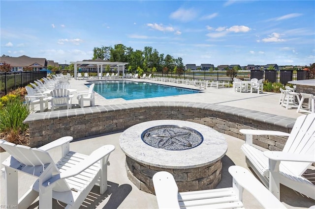 view of pool with a patio and an outdoor fire pit