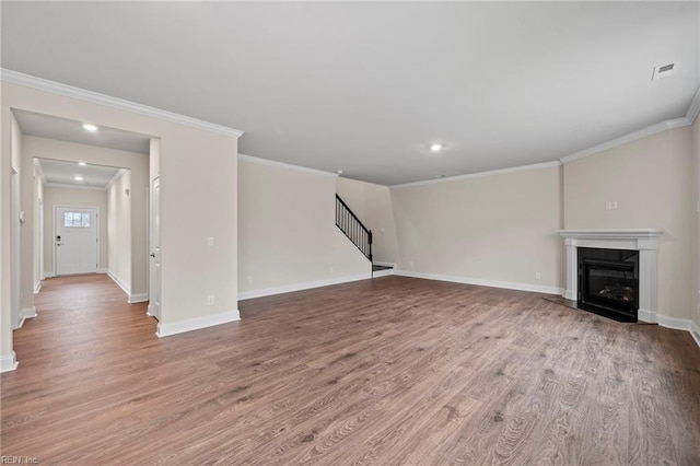 unfurnished living room featuring light wood-type flooring and crown molding