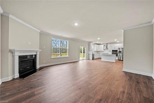 unfurnished living room with crown molding and wood-type flooring