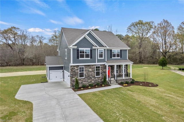 view of front of house with covered porch, a garage, an outbuilding, and a front lawn