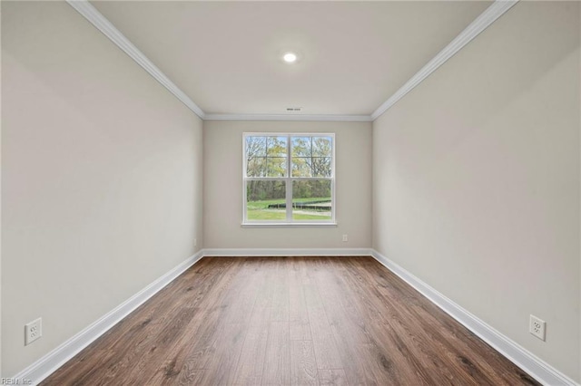 empty room featuring hardwood / wood-style flooring and ornamental molding