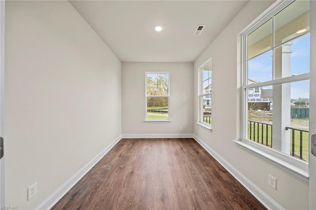 unfurnished room featuring dark wood-type flooring