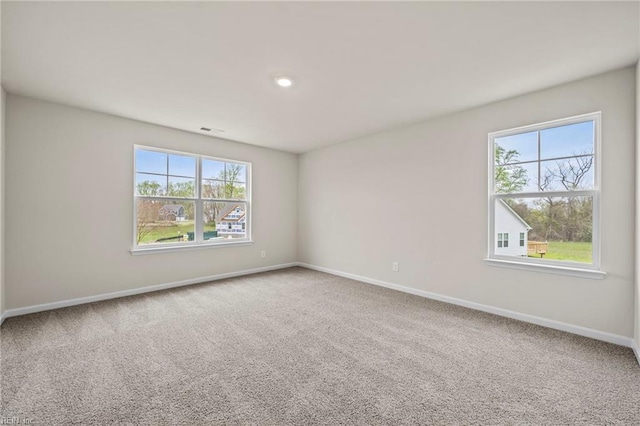 carpeted empty room with a healthy amount of sunlight