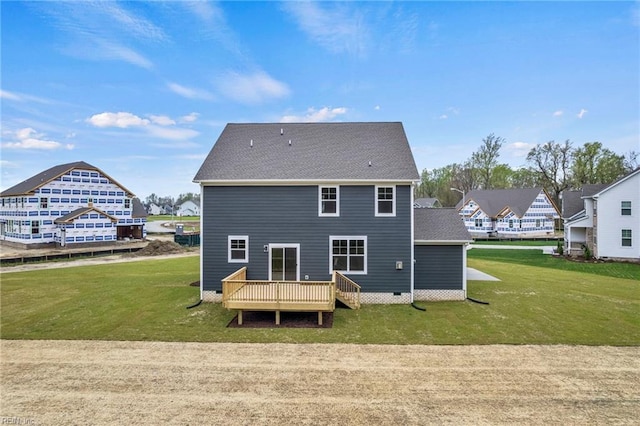 back of property featuring a lawn and a deck