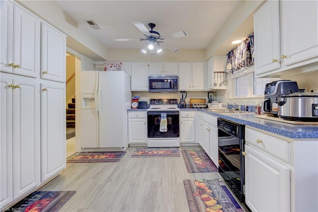 kitchen featuring white cabinetry, sink, white appliances, and ceiling fan