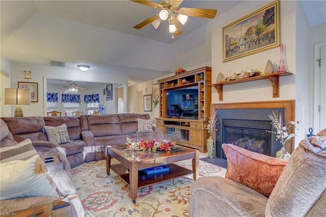 living room with ceiling fan and vaulted ceiling