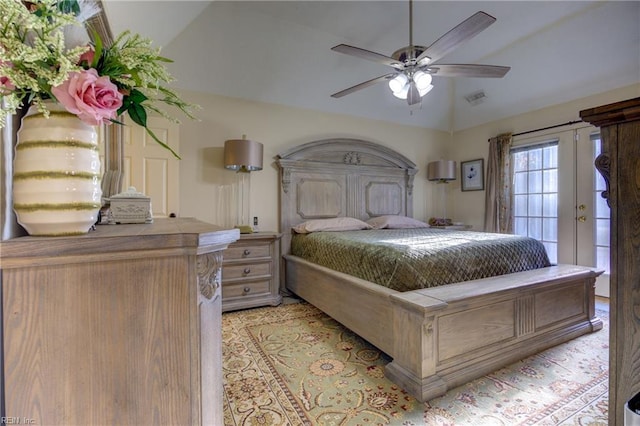 bedroom featuring ceiling fan, lofted ceiling, and french doors