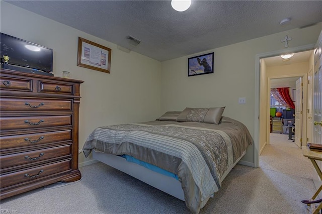 carpeted bedroom featuring a textured ceiling