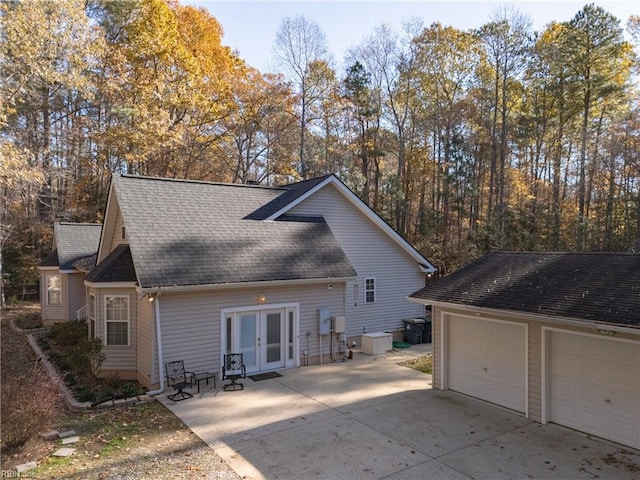 back of house featuring a garage and french doors