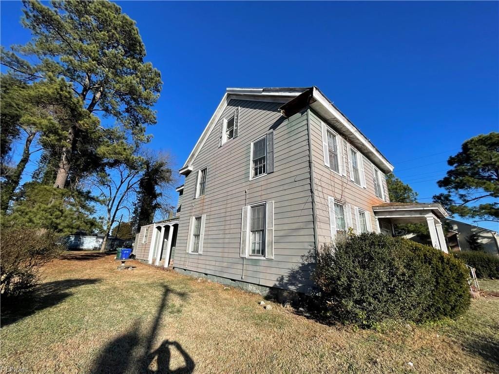 view of home's exterior with a yard