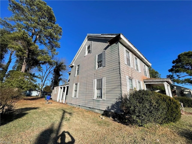 view of home's exterior with a yard