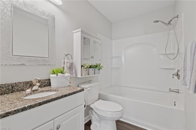 full bathroom featuring hardwood / wood-style floors, vanity, toilet, and shower / washtub combination