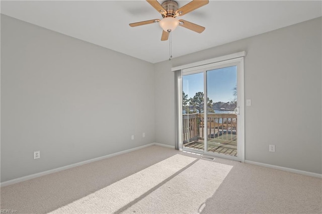 spare room featuring carpet floors and ceiling fan