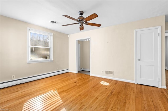 unfurnished bedroom featuring ceiling fan, baseboard heating, and light hardwood / wood-style floors