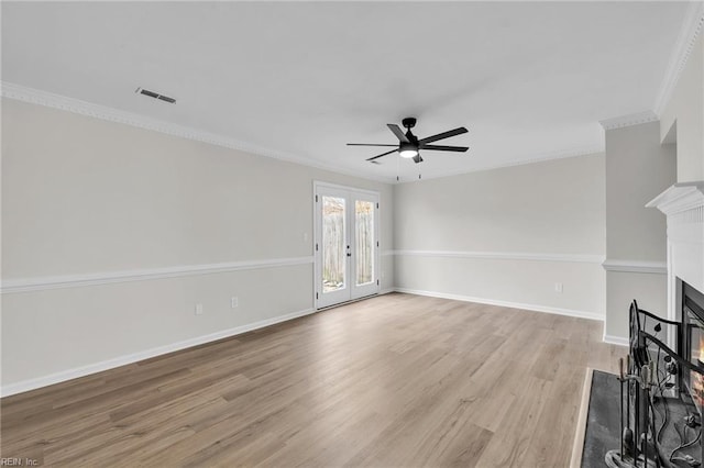 unfurnished living room with ceiling fan, light wood-type flooring, ornamental molding, and french doors