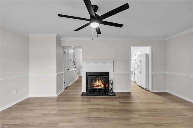 unfurnished living room featuring ceiling fan, light wood-type flooring, and crown molding