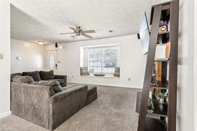 carpeted living room featuring a textured ceiling and ceiling fan