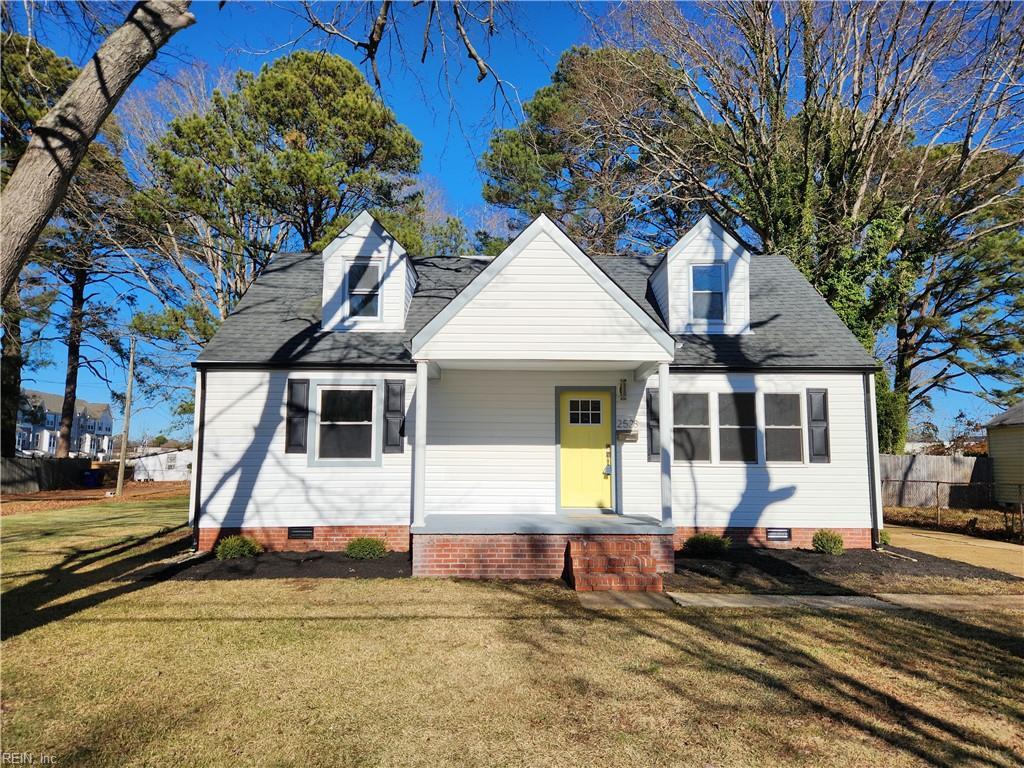 cape cod-style house with covered porch and a front lawn