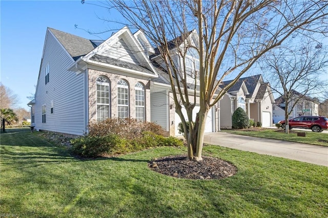 view of front of house featuring a garage and a front lawn