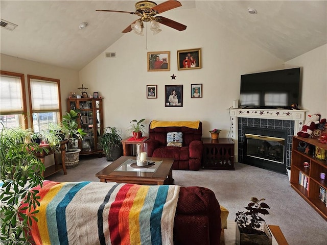 living room featuring carpet flooring, ceiling fan, and vaulted ceiling