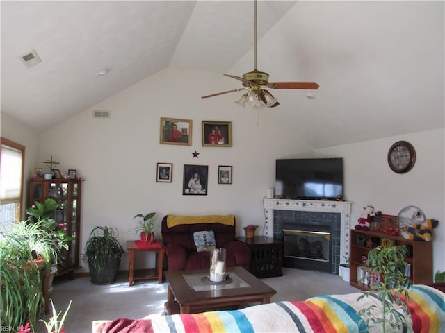 carpeted living room featuring ceiling fan, lofted ceiling, and a tiled fireplace