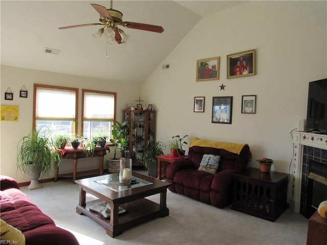 carpeted living room featuring ceiling fan, a fireplace, and lofted ceiling