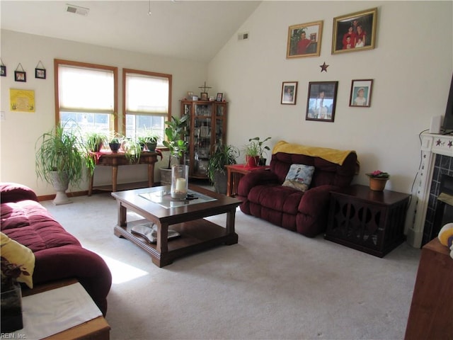 carpeted living room featuring vaulted ceiling