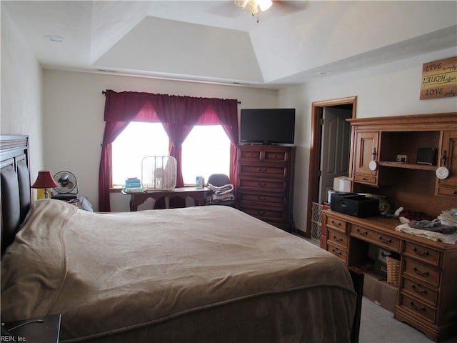 bedroom featuring a raised ceiling and ceiling fan