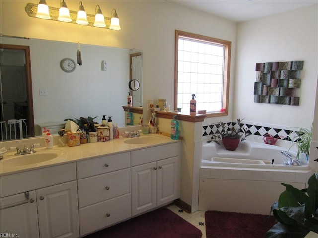 bathroom with vanity and tiled tub