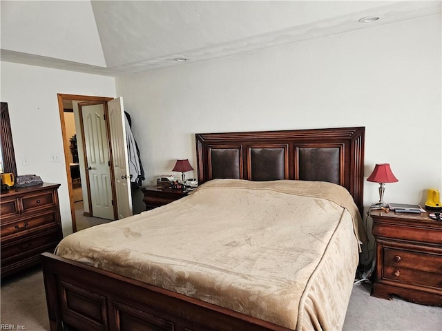 carpeted bedroom with vaulted ceiling