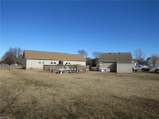 back of house featuring a yard and a wooden deck