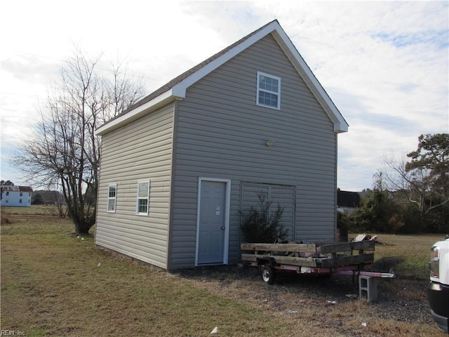 back of property featuring a lawn