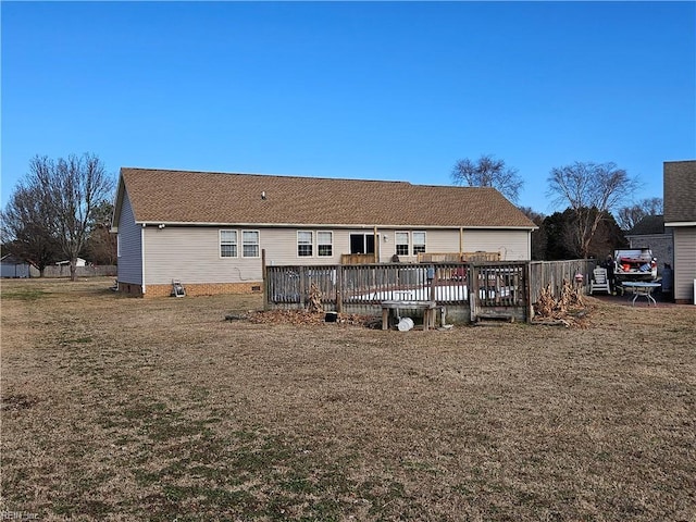 back of house featuring a yard and a wooden deck