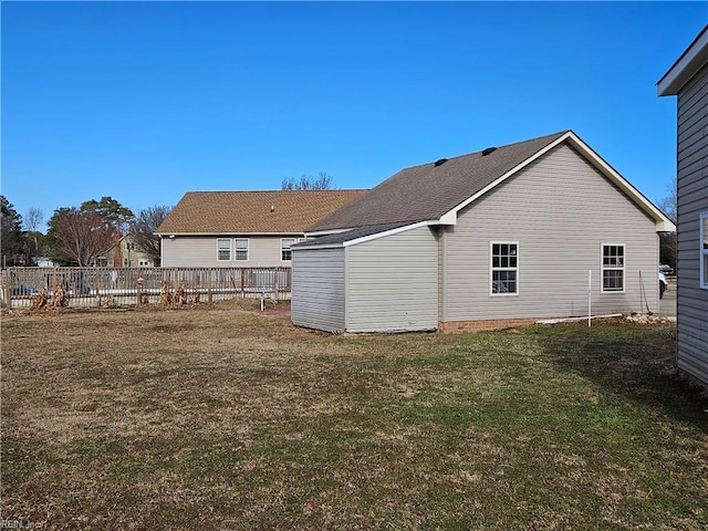 back of house with a lawn