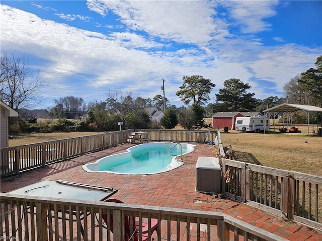 view of pool featuring a patio area, a yard, and a wooden deck