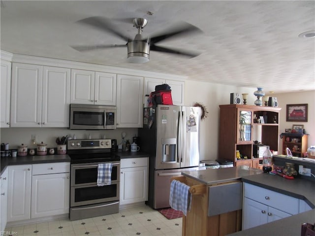 kitchen featuring white cabinets, ceiling fan, and appliances with stainless steel finishes