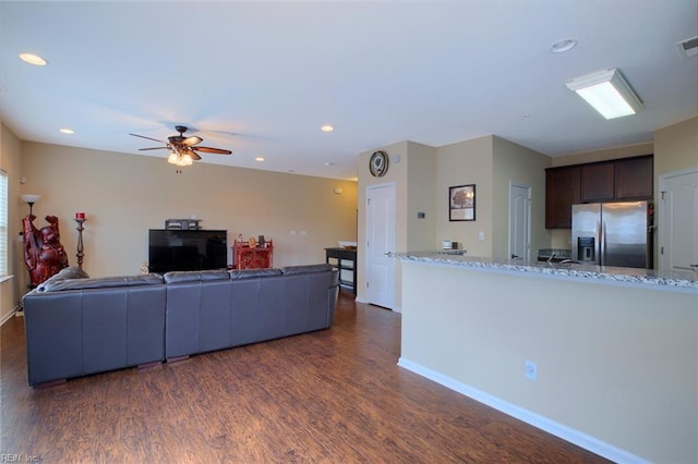 living room with dark hardwood / wood-style floors and ceiling fan