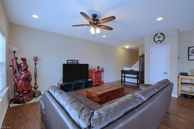 living room featuring dark hardwood / wood-style floors, plenty of natural light, and ceiling fan