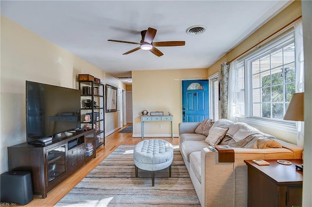 living room with ceiling fan and light hardwood / wood-style floors