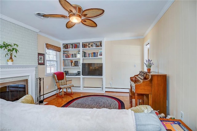 living area featuring a brick fireplace, a baseboard radiator, ceiling fan, and crown molding