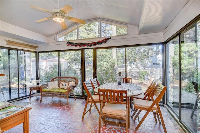 sunroom with lofted ceiling, ceiling fan, and a healthy amount of sunlight