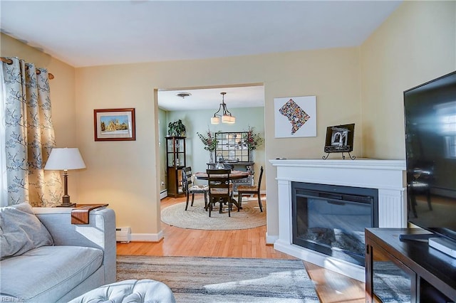 living room with hardwood / wood-style flooring and baseboard heating