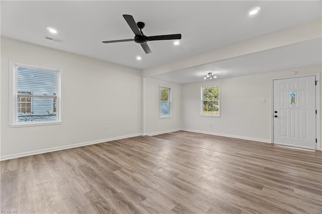 spare room featuring light wood-type flooring and ceiling fan